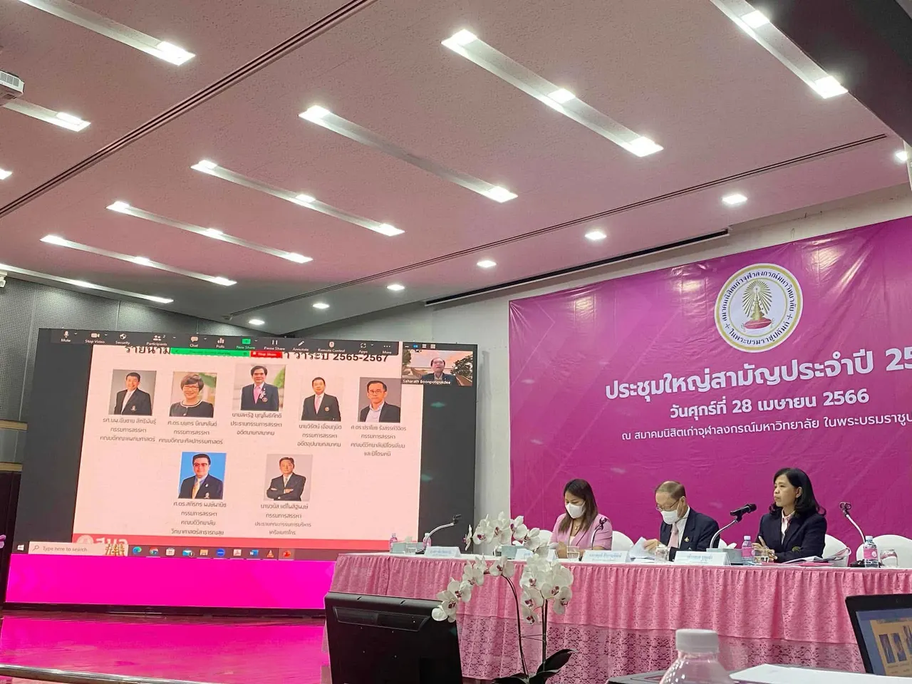 The candidates on screen at the meeting